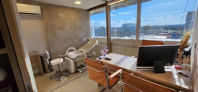 Sala de atendimento equipada com cadeira ginecológica, representando estrutura completa para cuidados com a saúde da mulher.