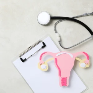 Ilustração do útero em exame ginecológico com estetoscópio ao lado.